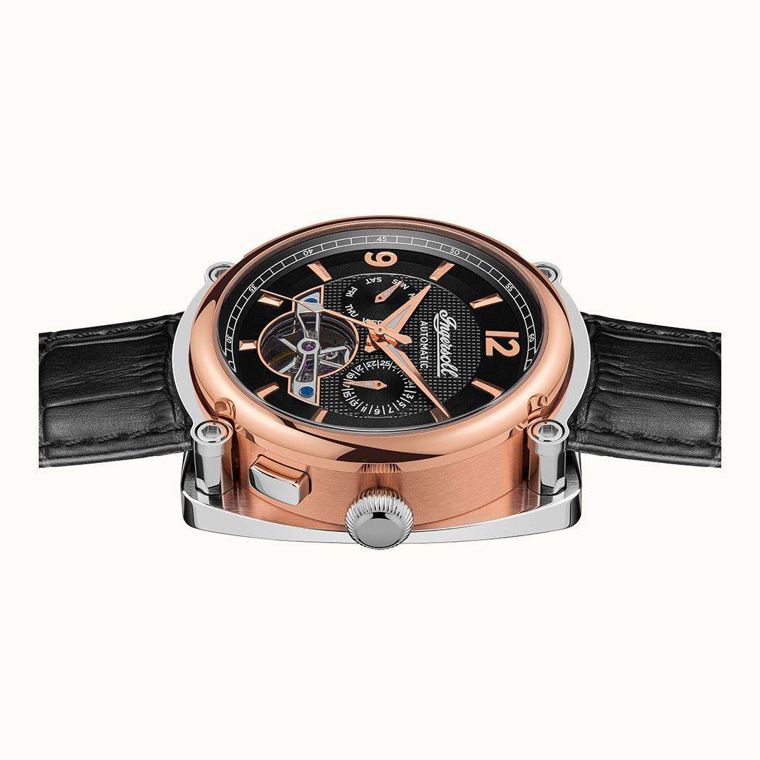 Men's automatic wristwatch top view: black dial, rose-gold case, and black leather strap.