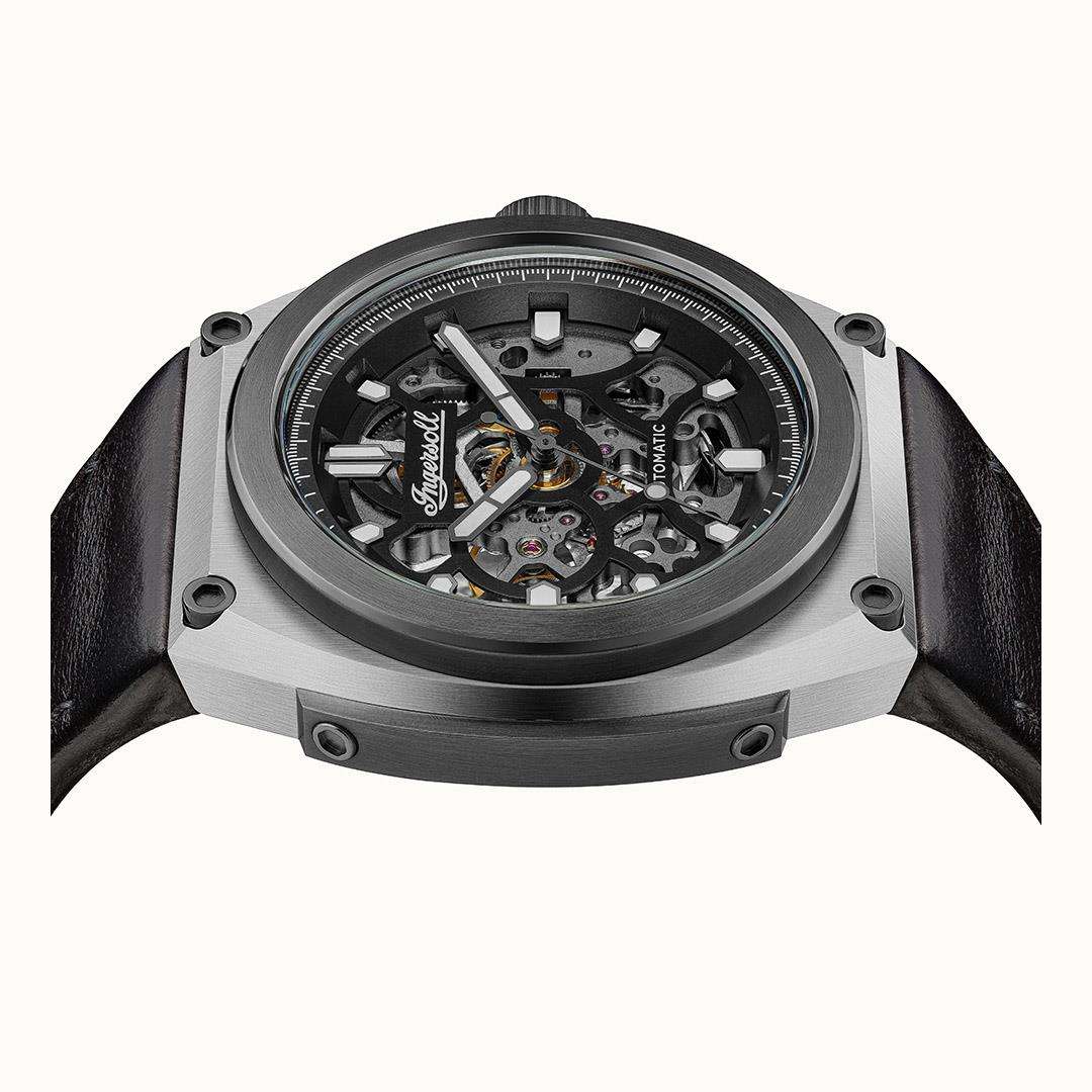 Automatic skeleton watch front view showing detailed gears and steel case ring