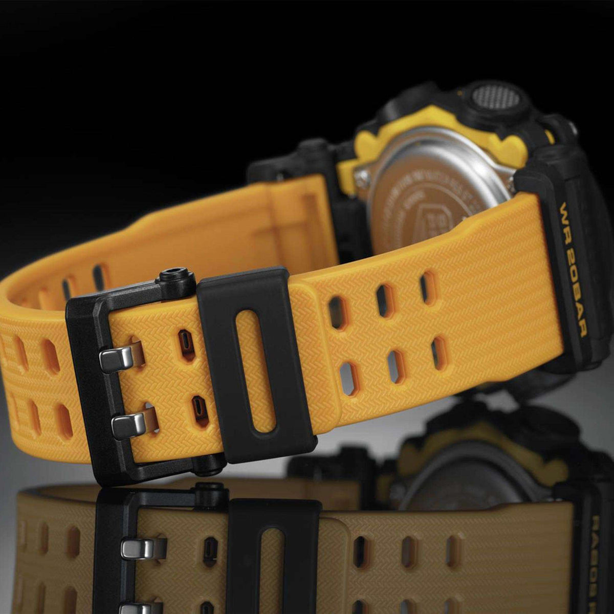Men's resin wristwatch with yellow perforated strap and black buckle, close-up