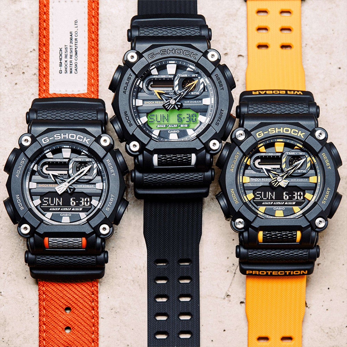 Set of three men's G-Shock watches with resin straps in black, orange, and yellow colors
