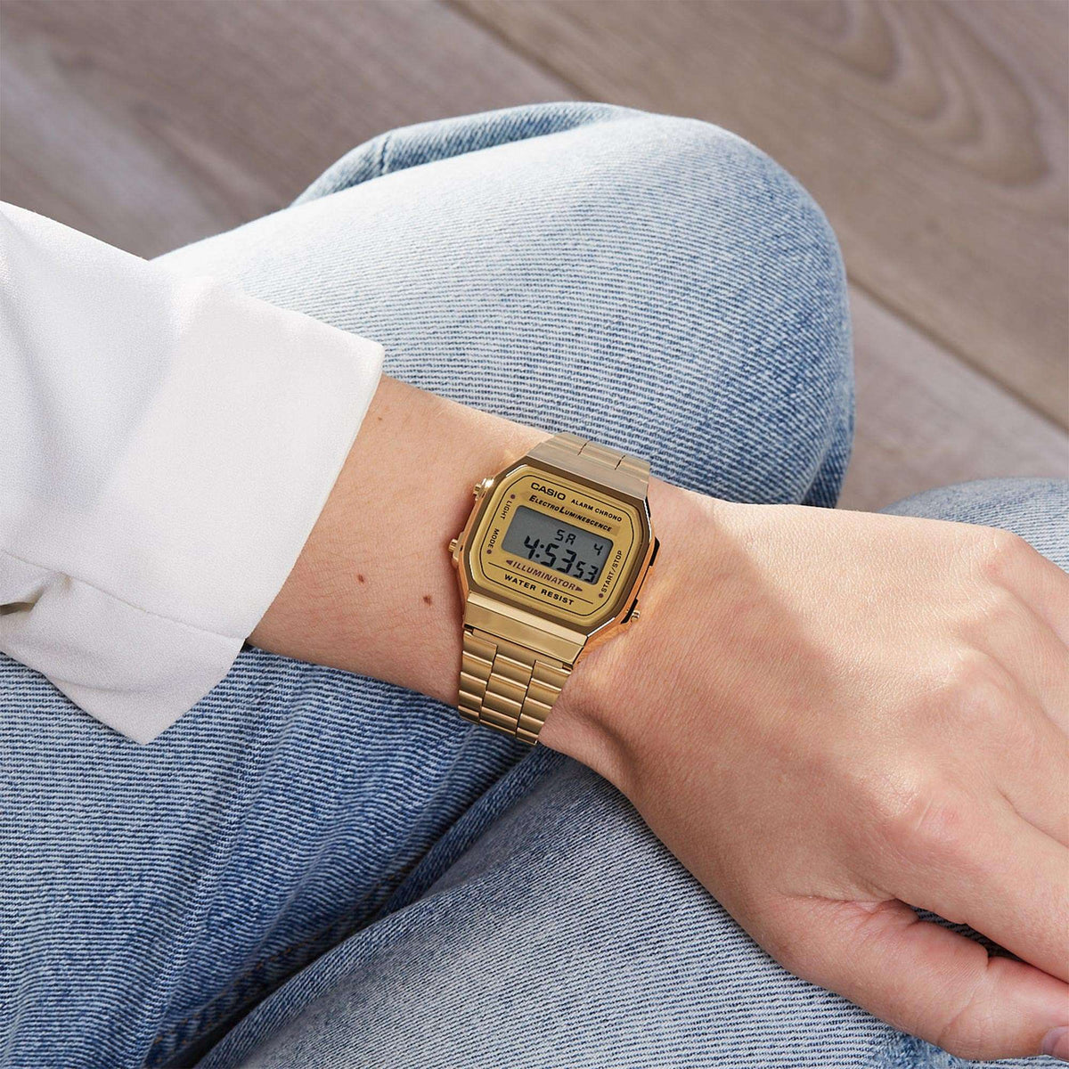 Casio gold-tone digital quartz watch worn on wrist with metal link bracelet