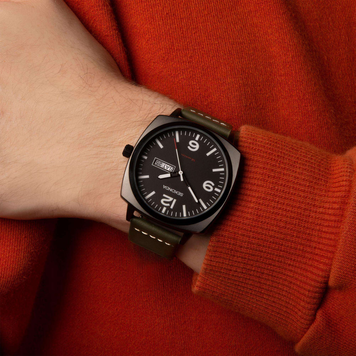 Sekonda men’s quartz watch on wrist with black dial and green strap, day/date display.