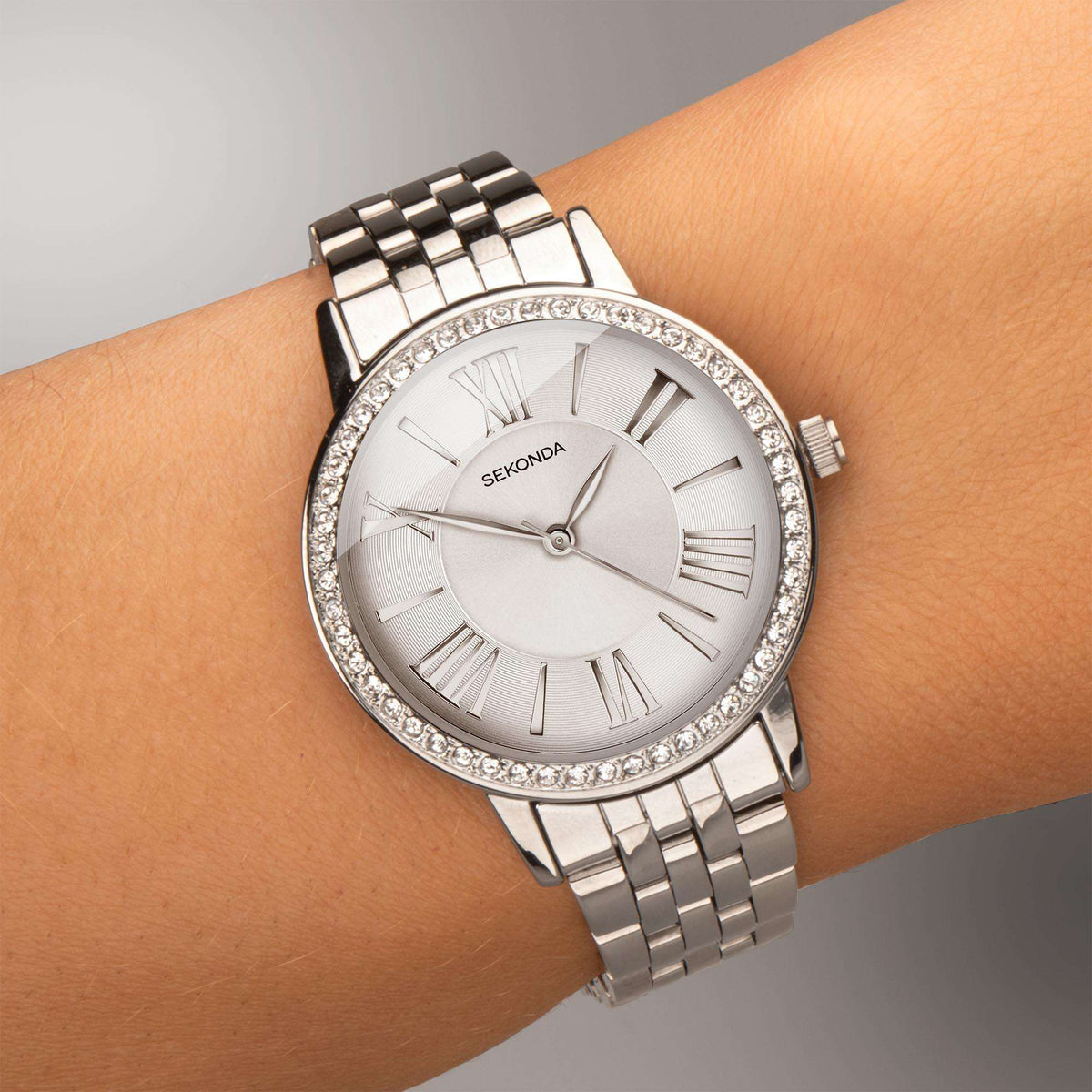 Sekonda ladies quartz watch on wrist, white dial with crystal bezel and metal bracelet