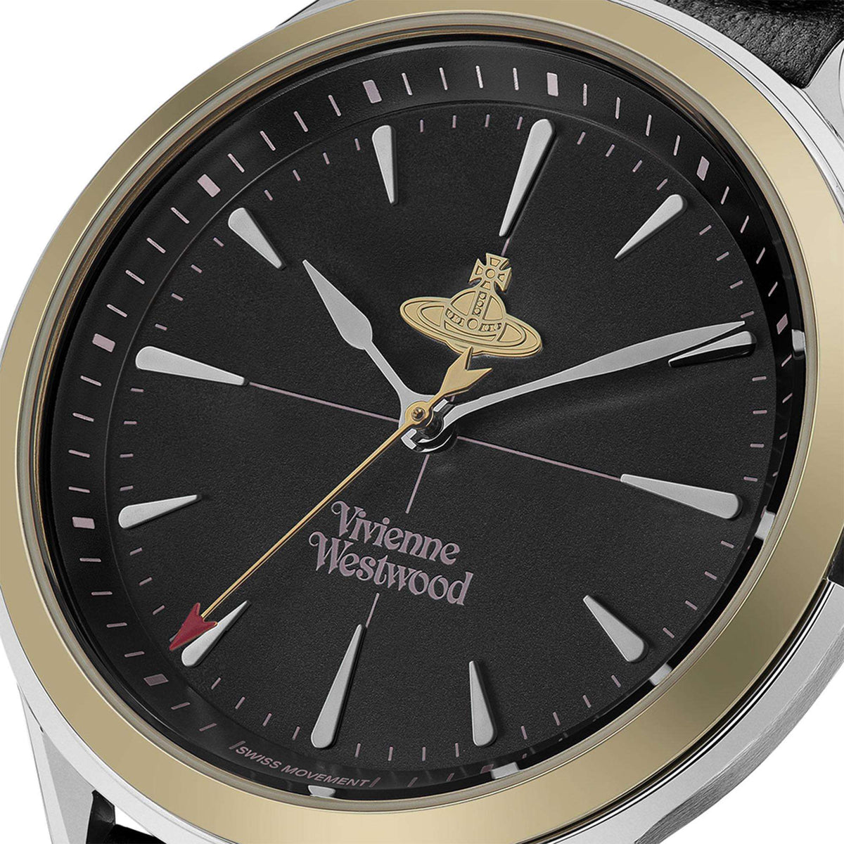Black dial watch face with gold emblem, silver hands, and gold-tone bezel ring