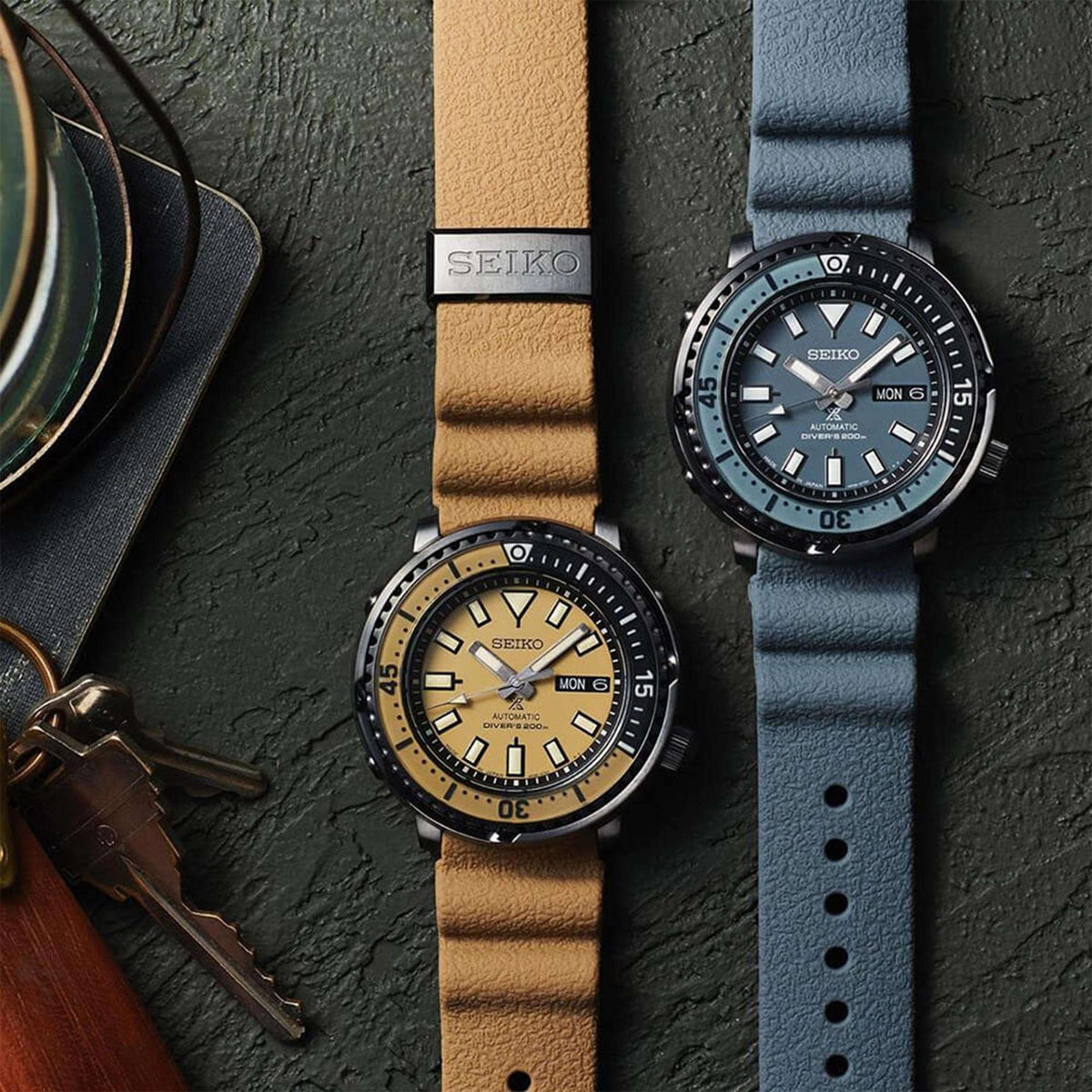 Beige-dial automatic diver watch with tan leather strap and black bezel, shown with blue dial