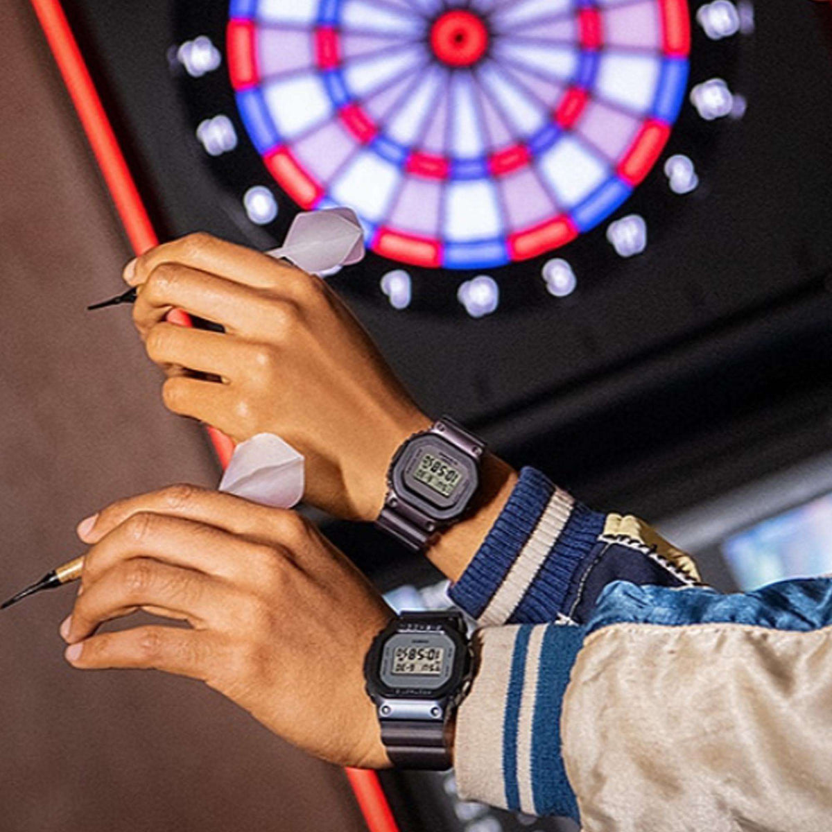 Casio G-Shock watch on wrist with purple resin strap during darts game