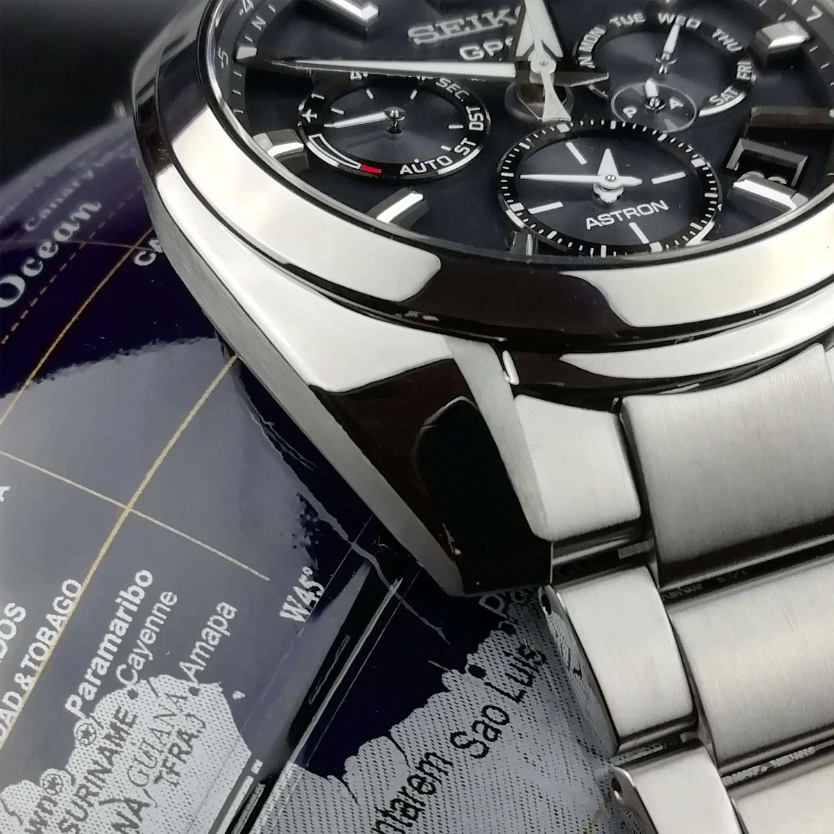 Men's Seiko GPS Solar watch detail, stainless steel bracelet links and black bezel