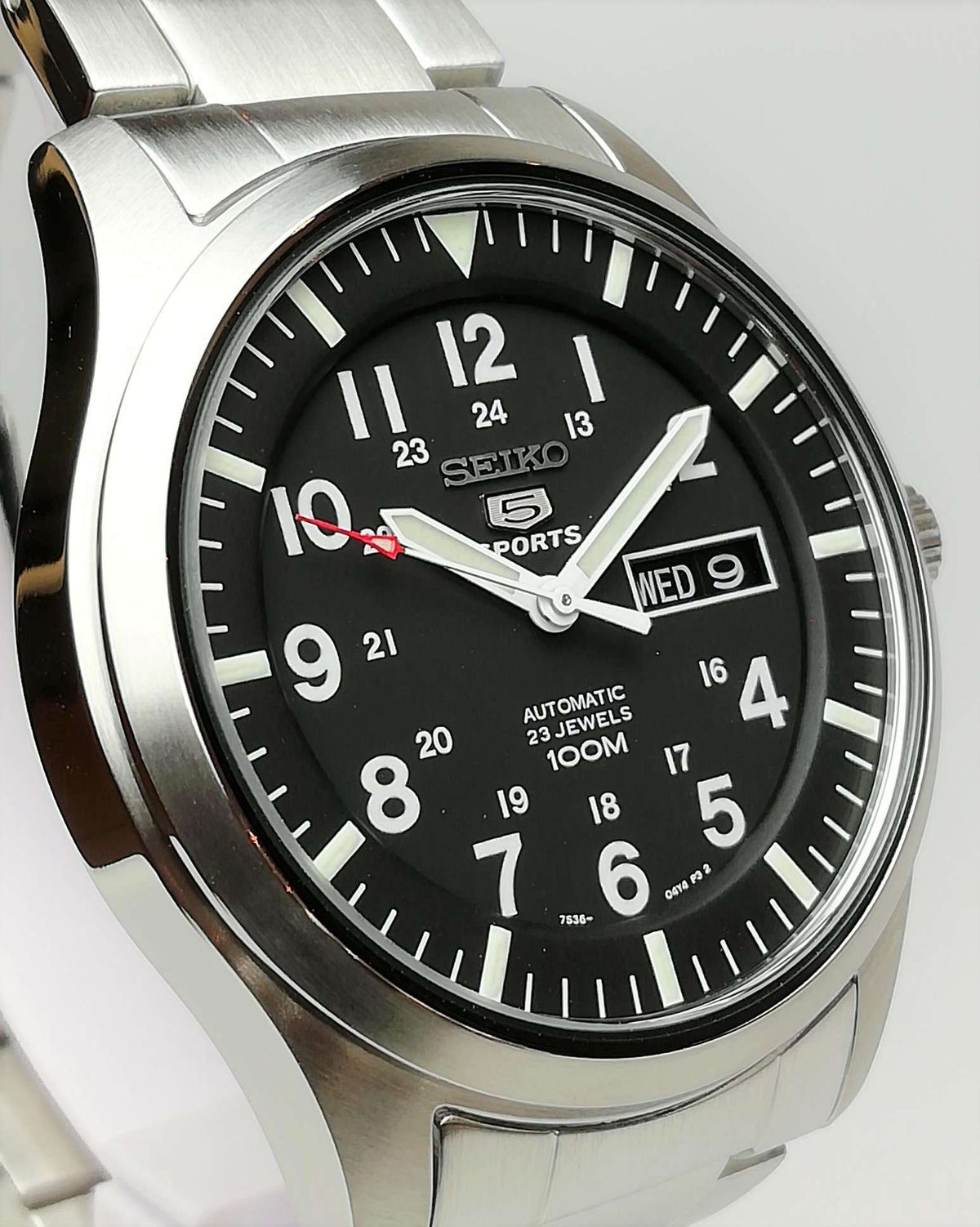Men's Seiko 5 Sports automatic watch with black dial, steel bracelet, and day-date window
