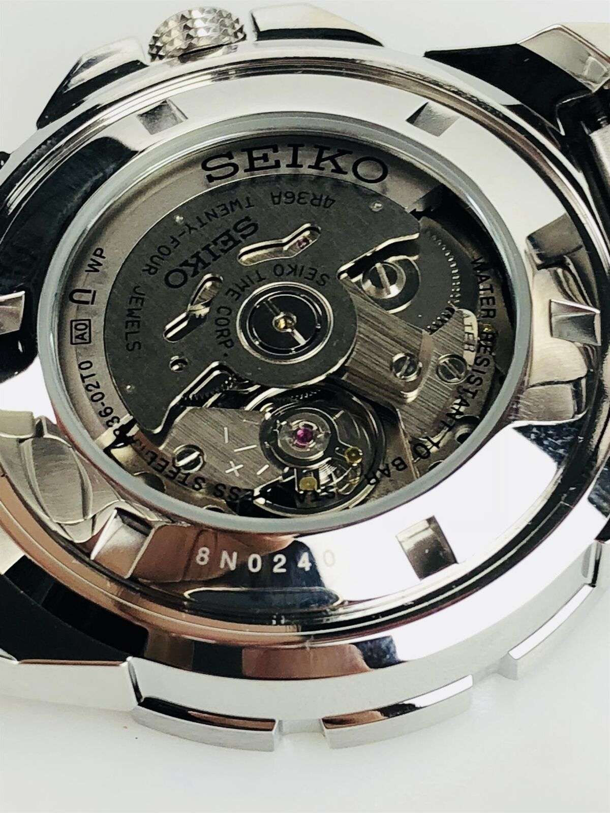Stainless steel watch caseback with SEIKO markings and visible mechanical movement