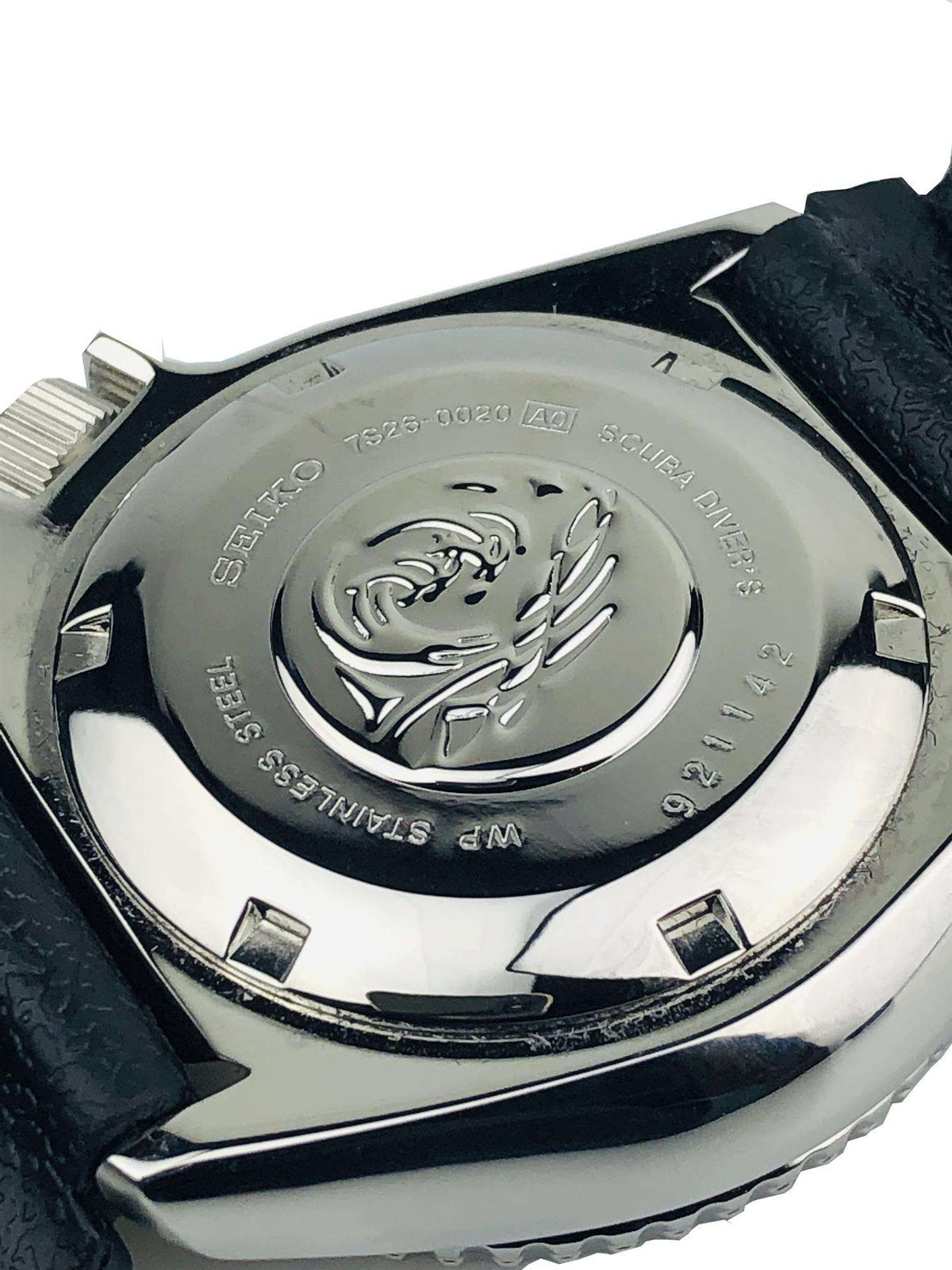 Seiko SKX diver watch caseback with engraved dolphin emblem on steel back