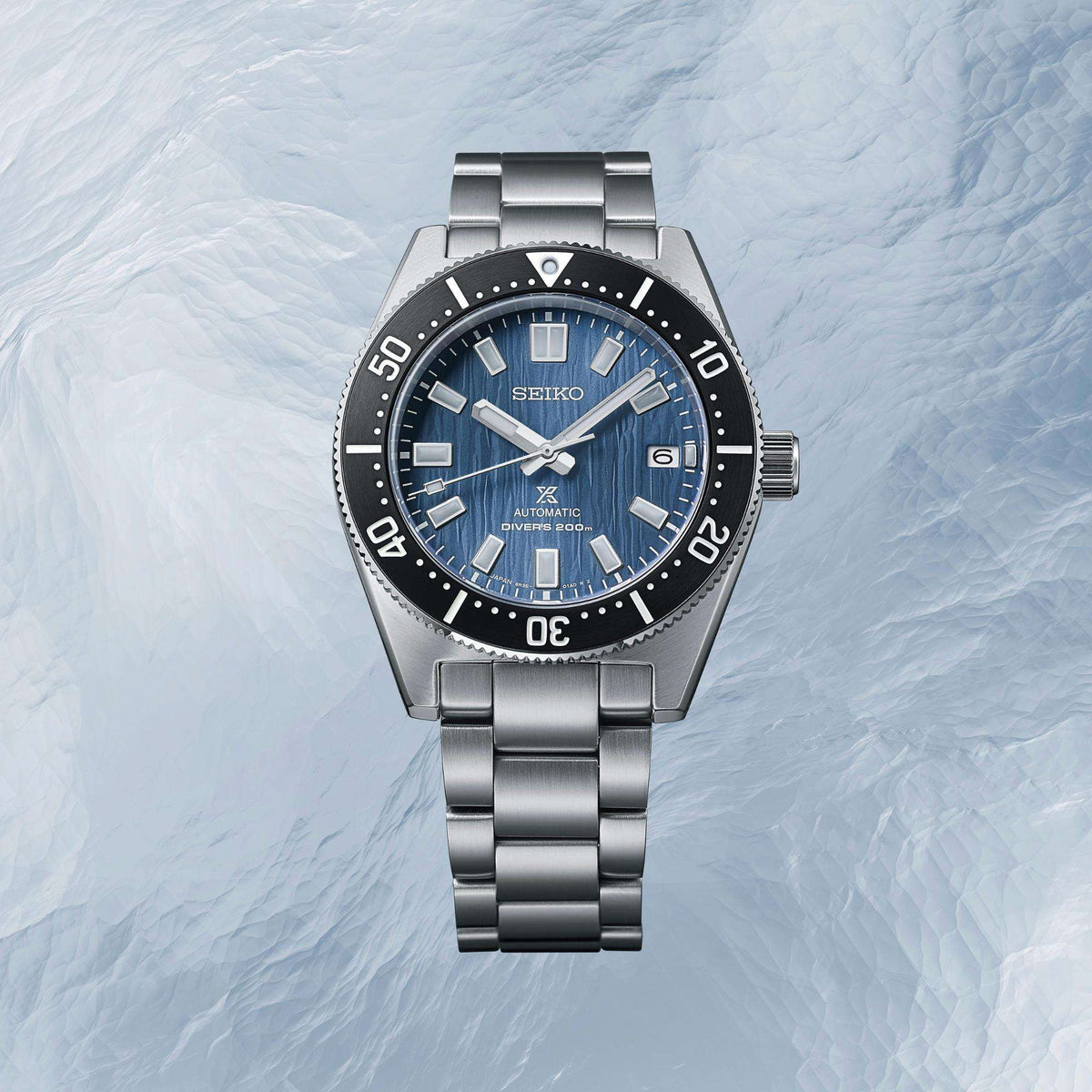 Seiko Prospex Save The Ocean Glacier 1965 Watch SPB297J1 positioned flat against a textured ice-like background.