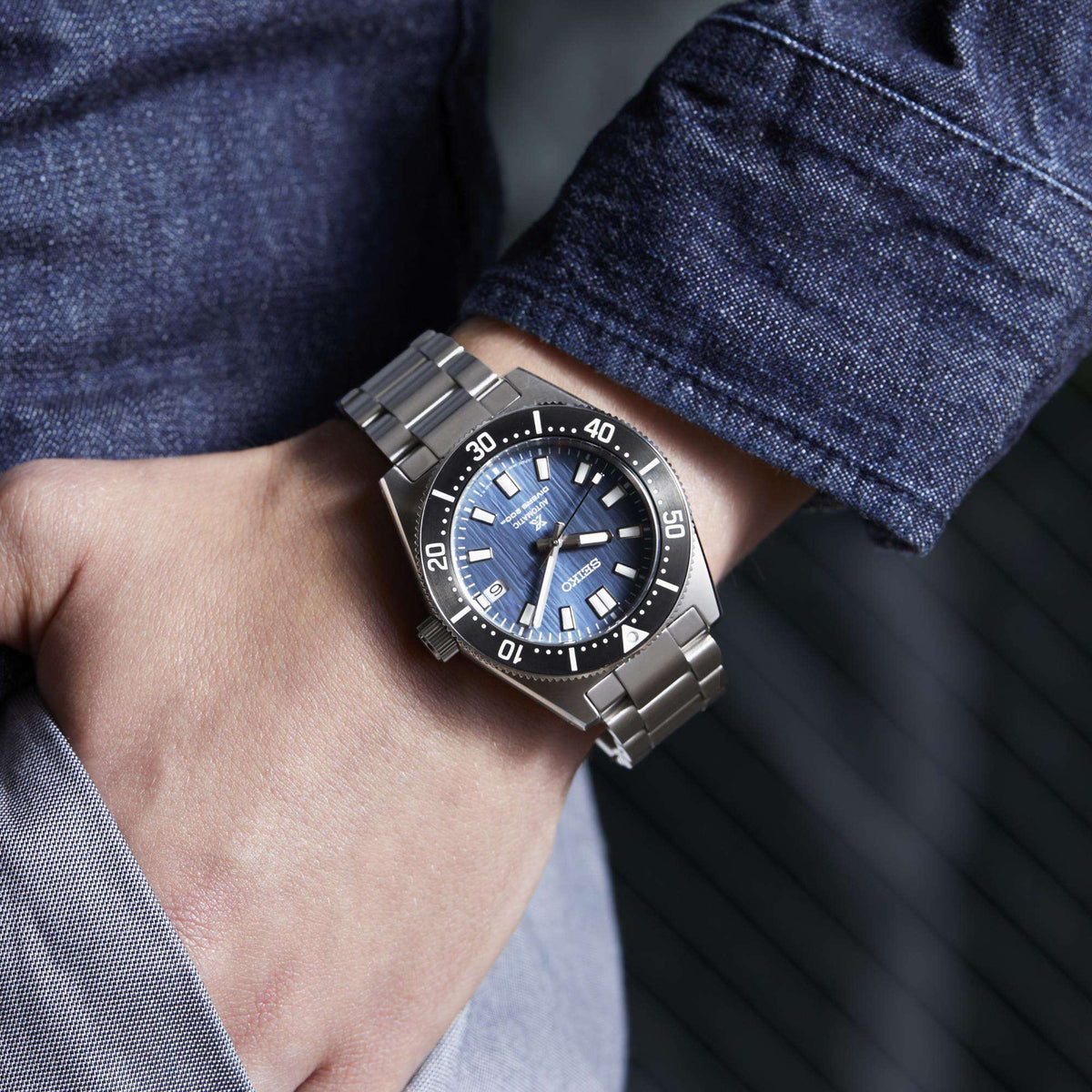 Seiko Prospex Save Watch SPB297J1 on a wrist with the hand tucked into a denim shirt pocket.