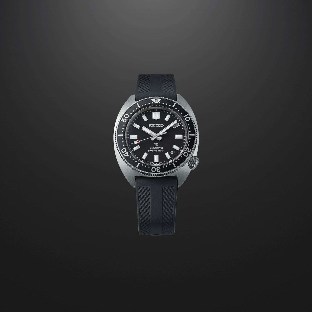 Seiko Prospex diver watch with black dial, knurled bezel, black rubber strap