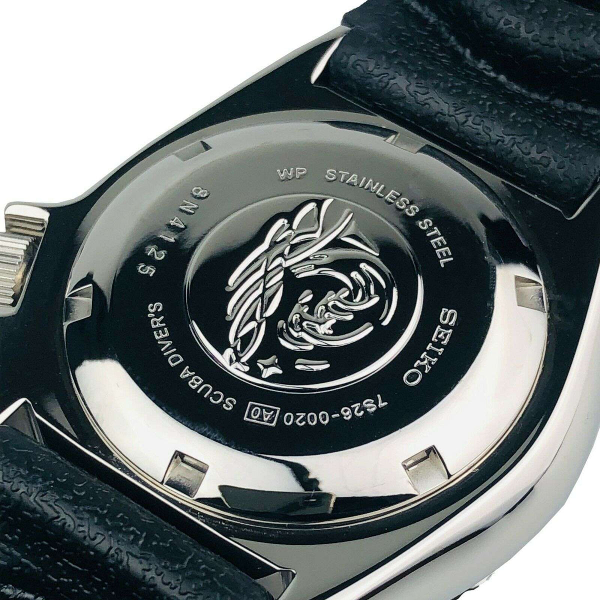Stainless steel caseback with dive emblem and text, on black rubber strap