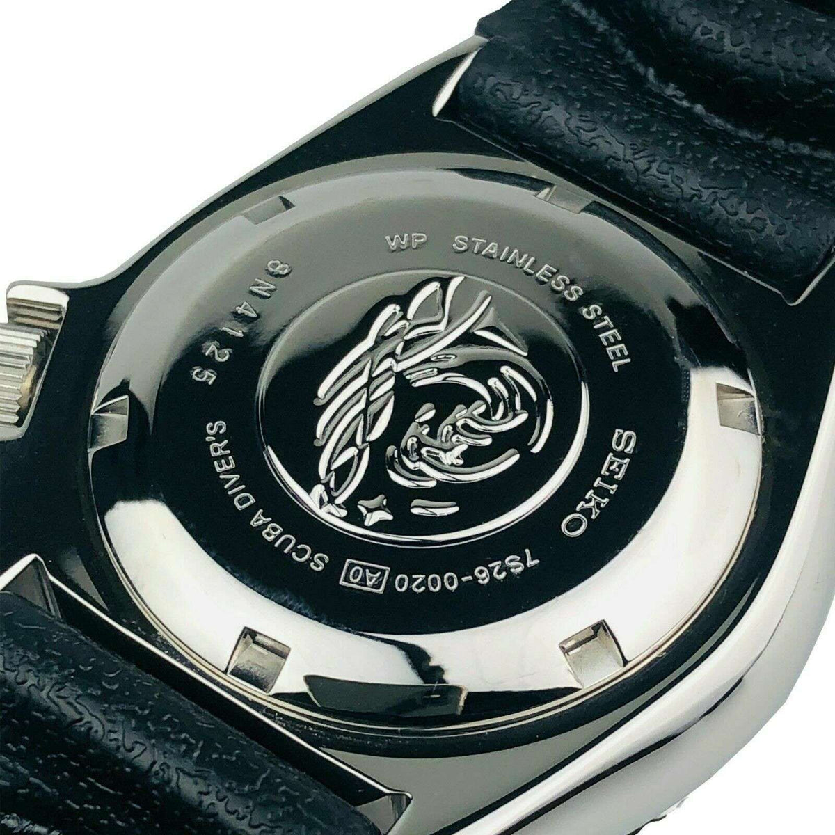 Seiko diver watch caseback with engraved dragon emblem on metal back
