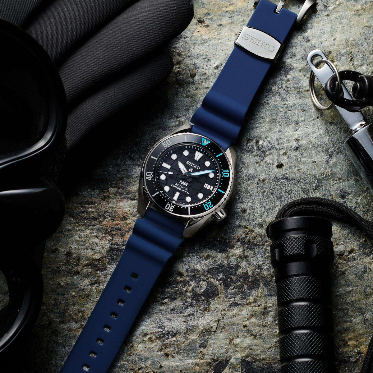 Seiko Prospex diver watch with black dial, blue silicone strap, steel case and crown