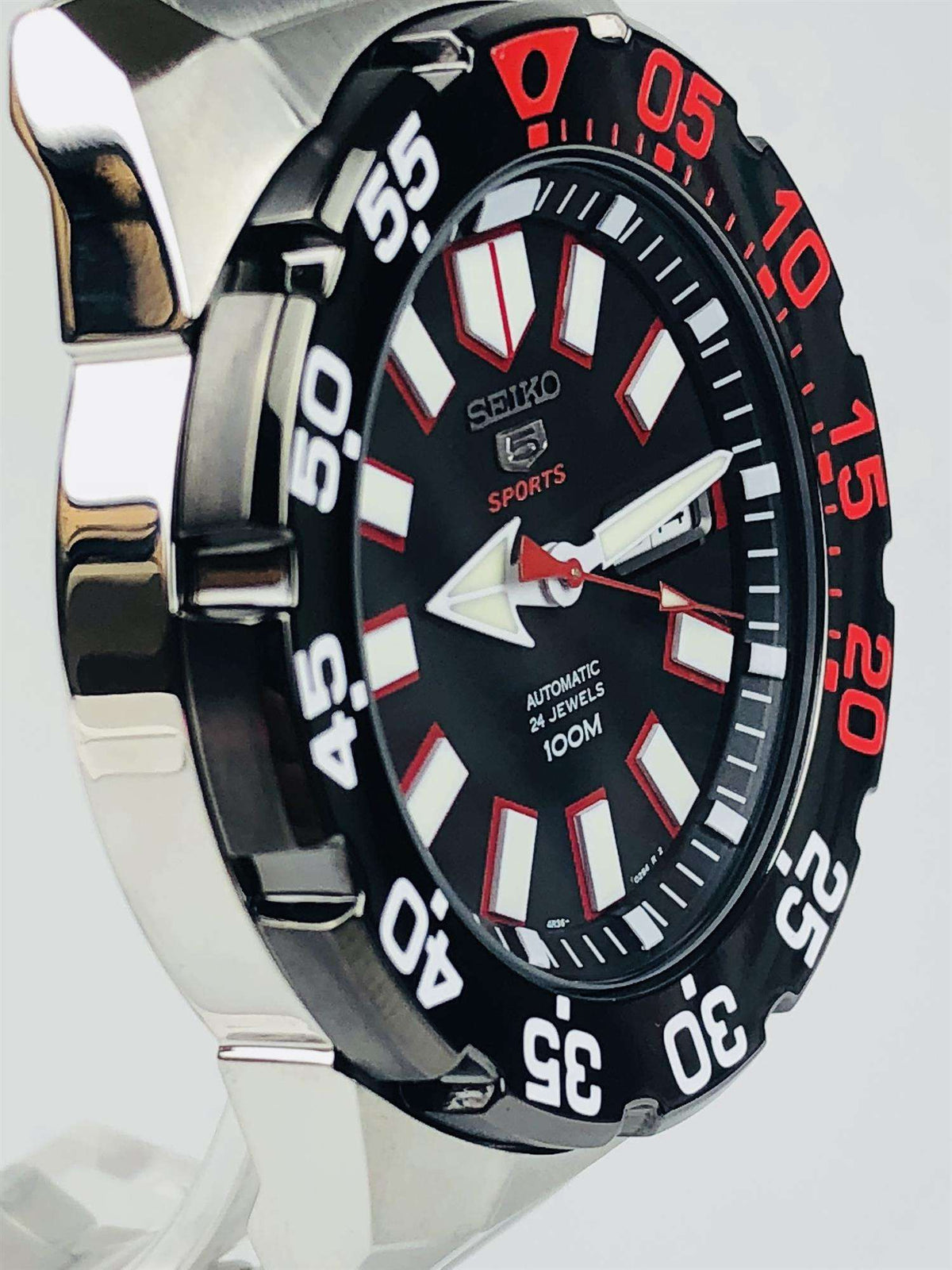 Three-quarter view of men's Seiko Sports automatic watch with black dial and steel bracelet