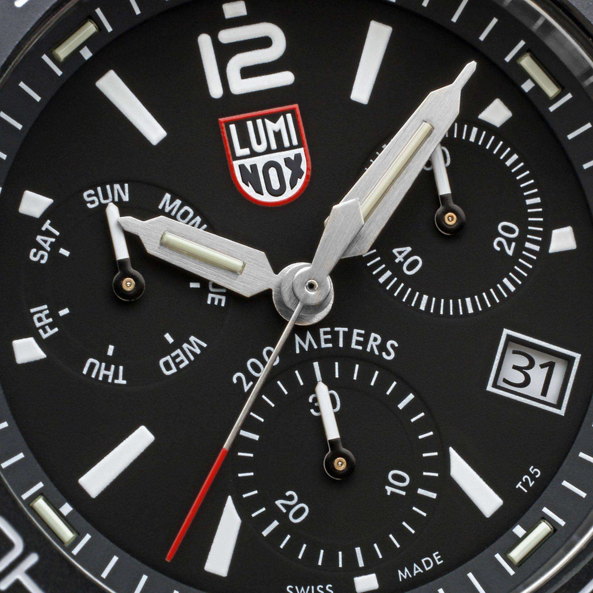 Stainless steel diver chronograph watch dial close-up with three subdials and luminous hands