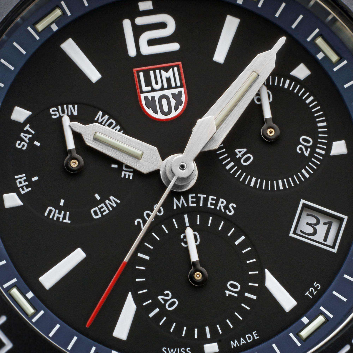 Close-up of black chronograph dial with luminous markers, LUMINOX logo, and subdials
