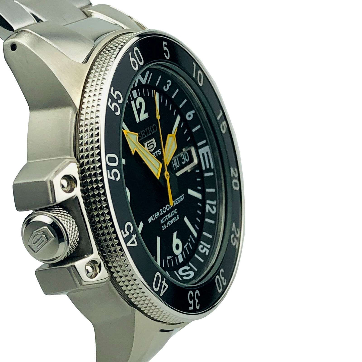 Men's stainless steel sports watch angled close-up with black dial and yellow pointer hands