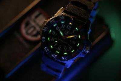 Men's black quartz watch with luminous bezel markings and black silicone strap