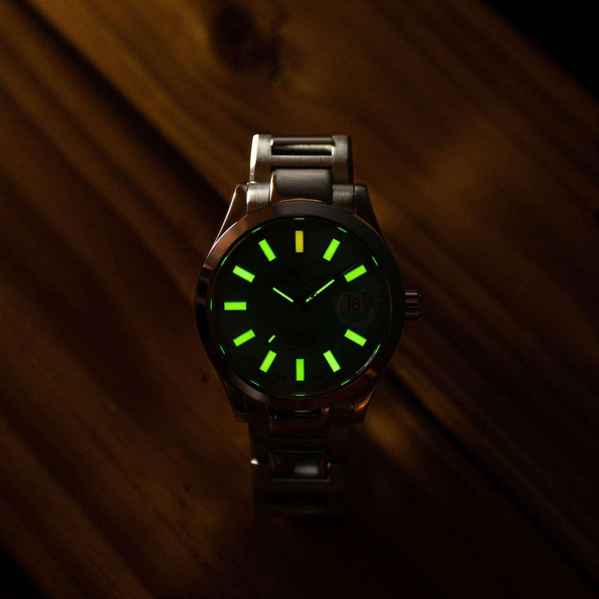Mens black watch on side angle with green luminous dial and black bracelet