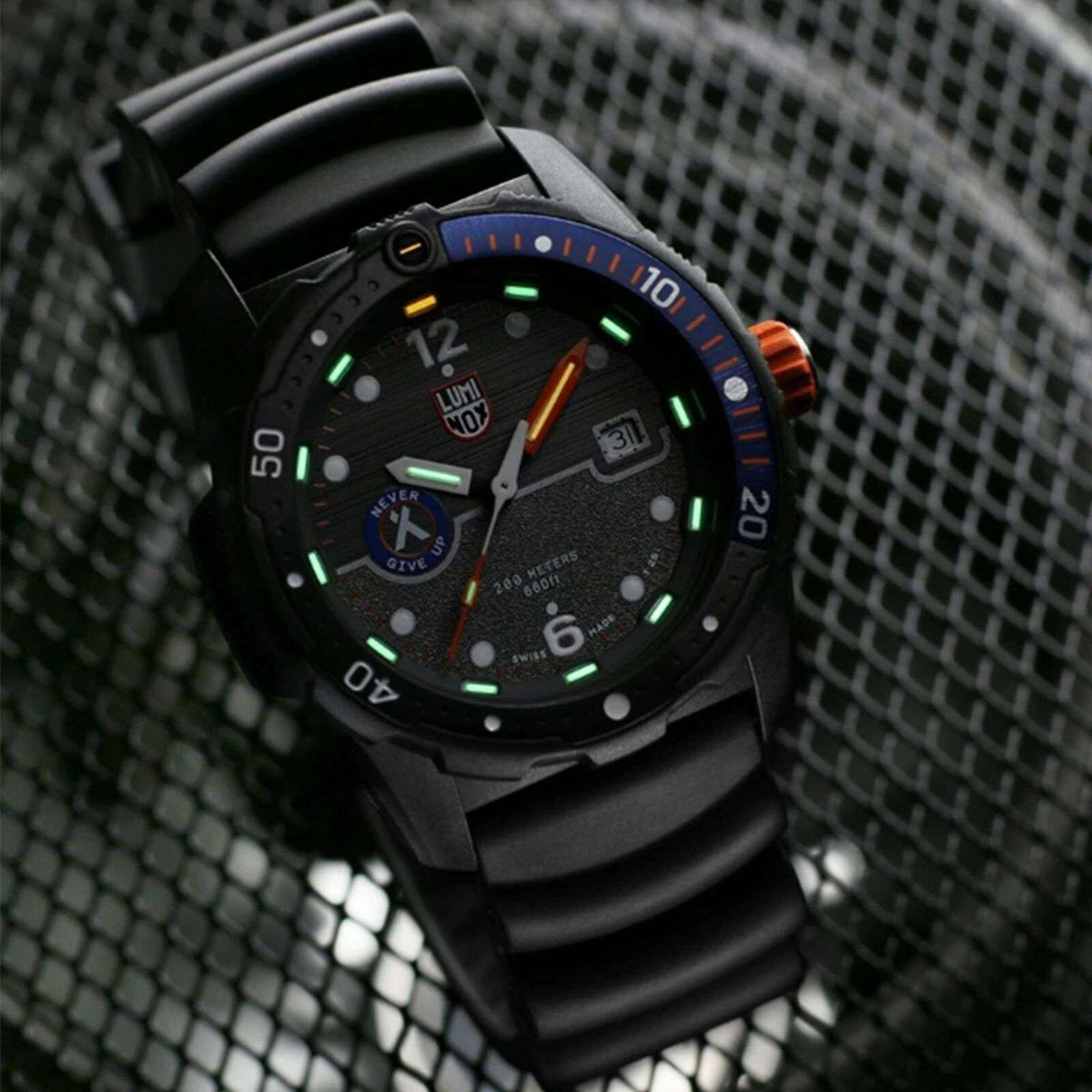 Black 42mm men's quartz watch with blue bezel ring, luminescent markers, rubber strap.