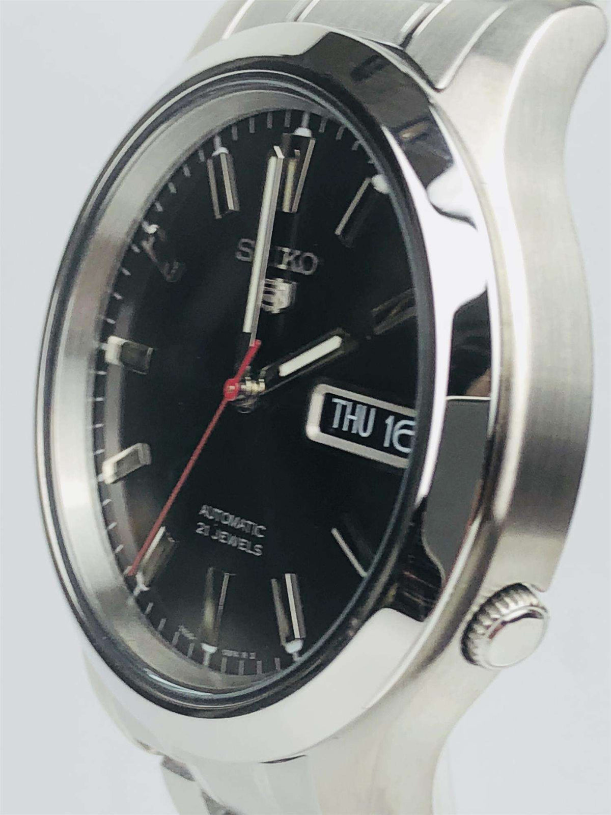 Men's stainless steel automatic watch with black dial, visible crown, and date window.