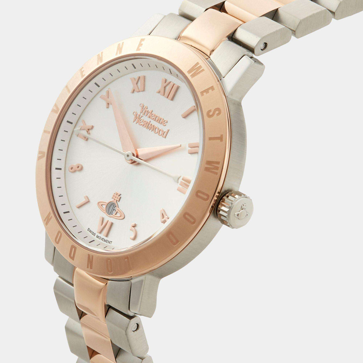 Round two-tone watch face with silver dial, Roman numerals, and rose-gold bezel and markers