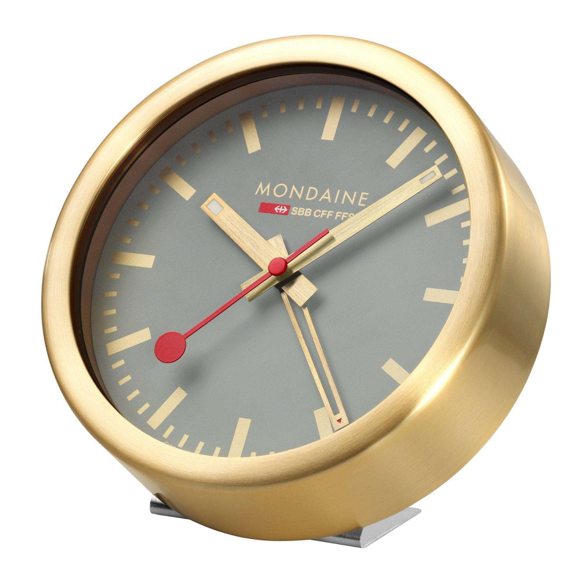 Mondaine alarm clock angled view with grey dial, gold bezel, red second hand