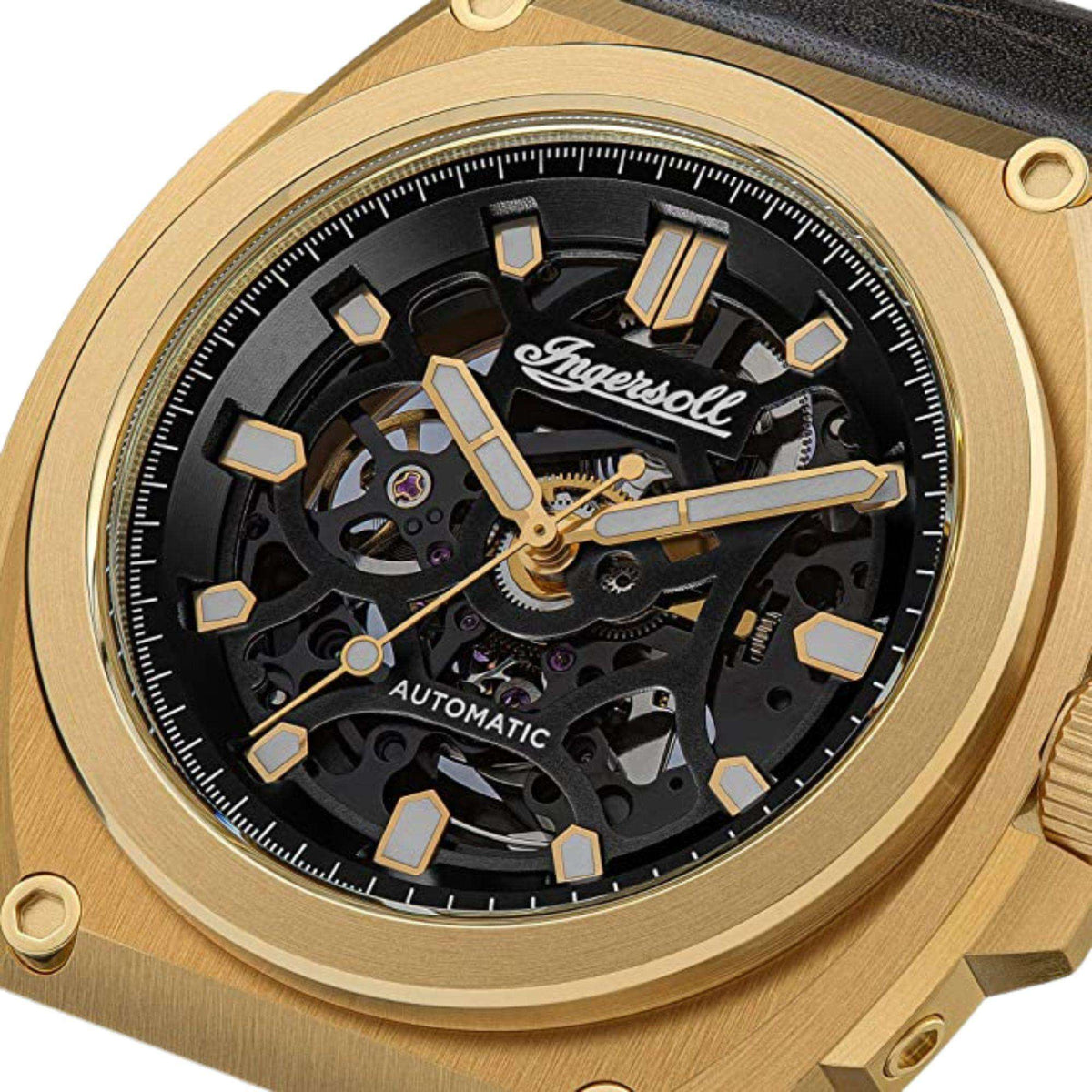 Close-up of gold-tone automatic skeleton watch face with black dial and visible gears