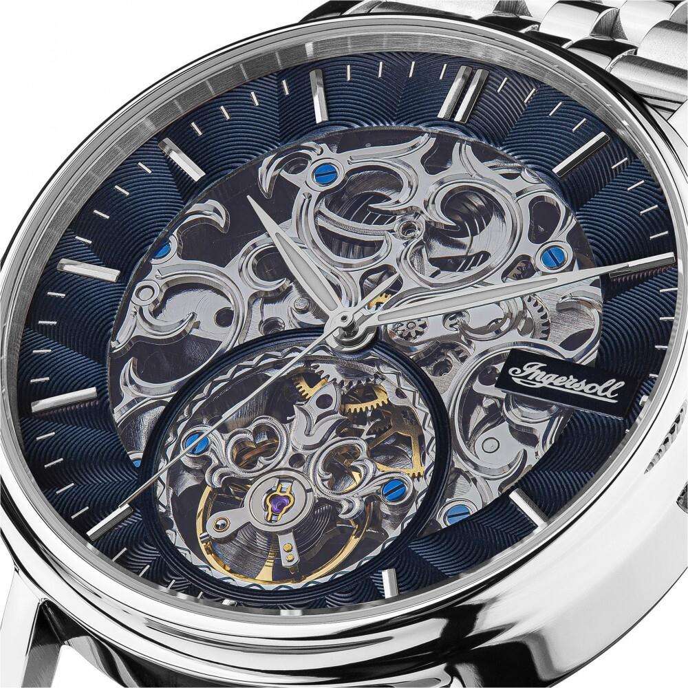 Close-up of automatic watch skeleton dial with dark blue face and silver movement details