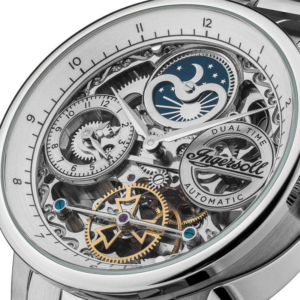 Close-up of silver skeleton dial with blue moon, subdial, and visible automatic gears