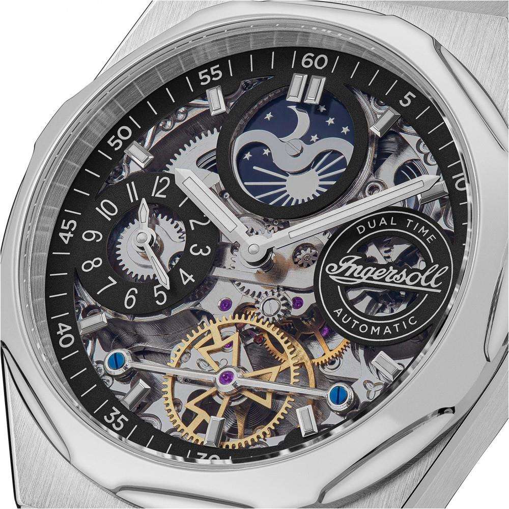 Close-up of stainless steel watch movement with Dual Time moon and stars dial