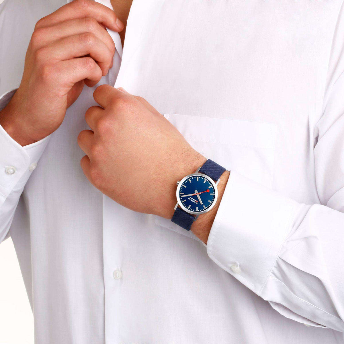 Mondaine Classic 40mm quartz watch worn on wrist, deep blue dial and blue textile strap