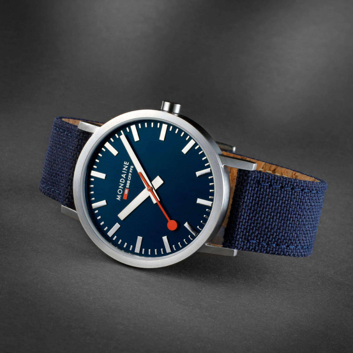 Mondaine Classic 40mm watch close-up with deep blue dial and blue textile strap