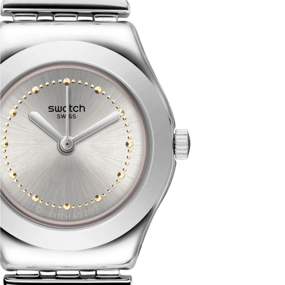 Stainless steel watch case close-up with white dial, gold dot bezel markers