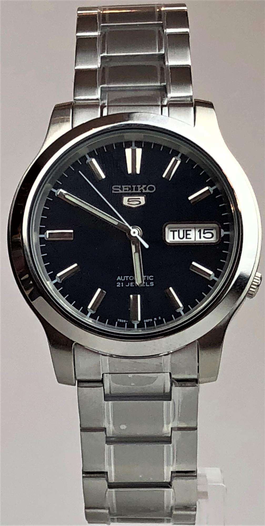 Men's steel automatic watch with blue dial and metal bracelet, date window showing TUE 15