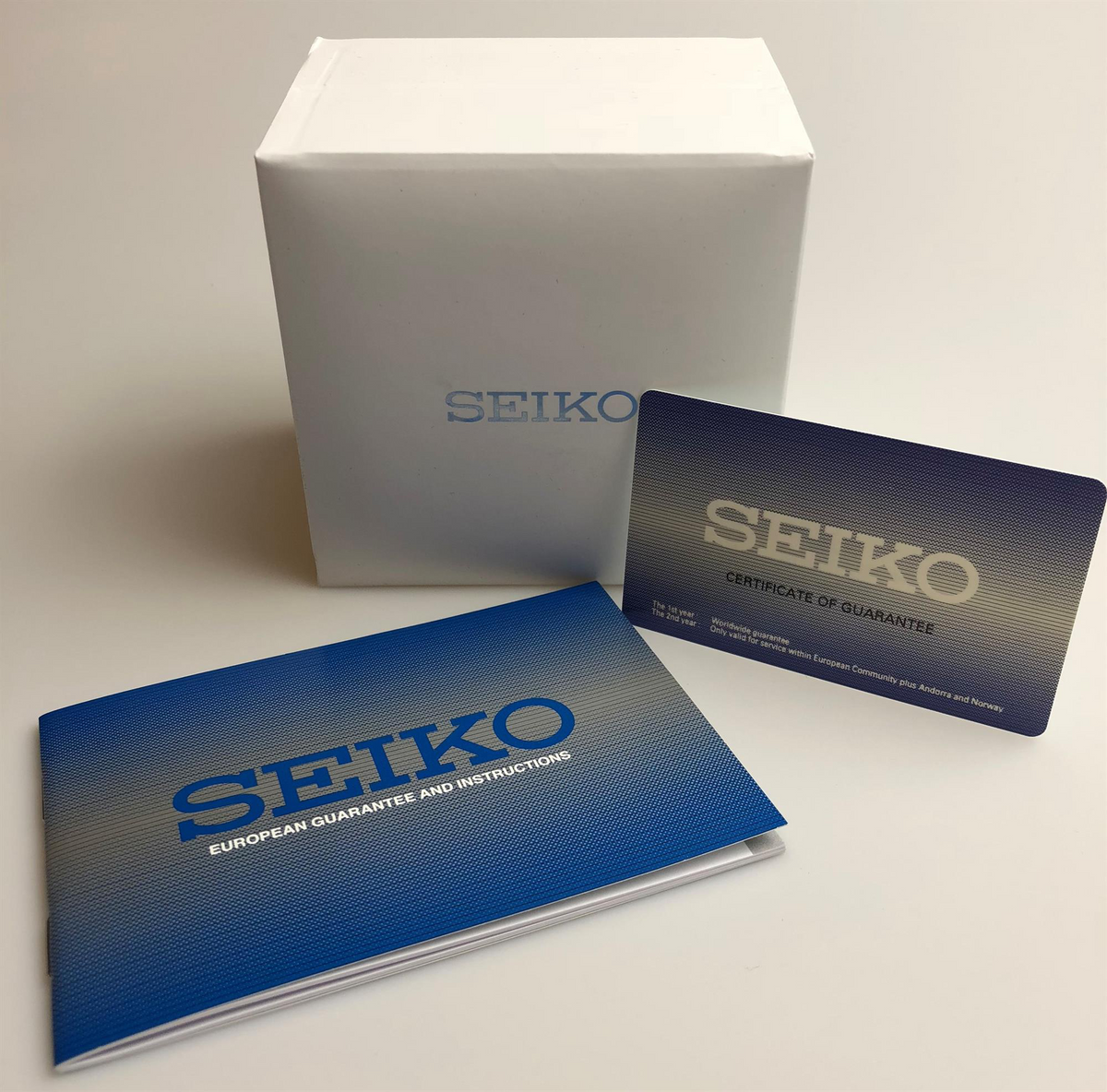 Seiko 5 warranty certificate and instruction cards with blue SEIKO text