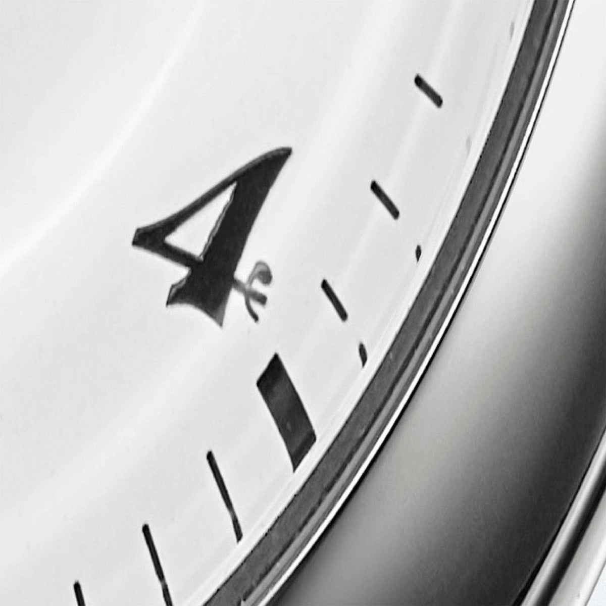 Extreme close-up zoom of the Arabic numeral '4' on the white dial, showcasing the painted font and fine details next to the minute track.