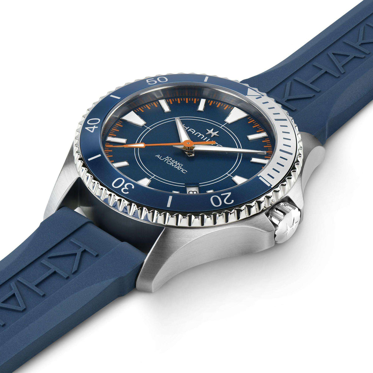 Men's diver watch angled view; blue dial with markers, steel bezel, blue textured rubber strap
