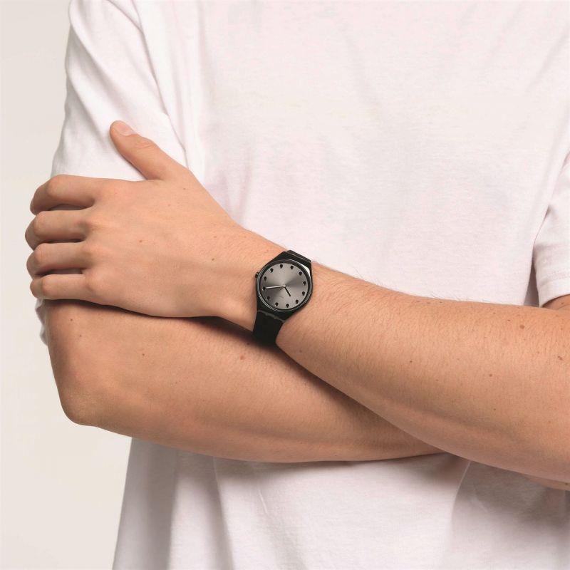 Ladies black leather-strap watch worn on wrist, dark dial visible