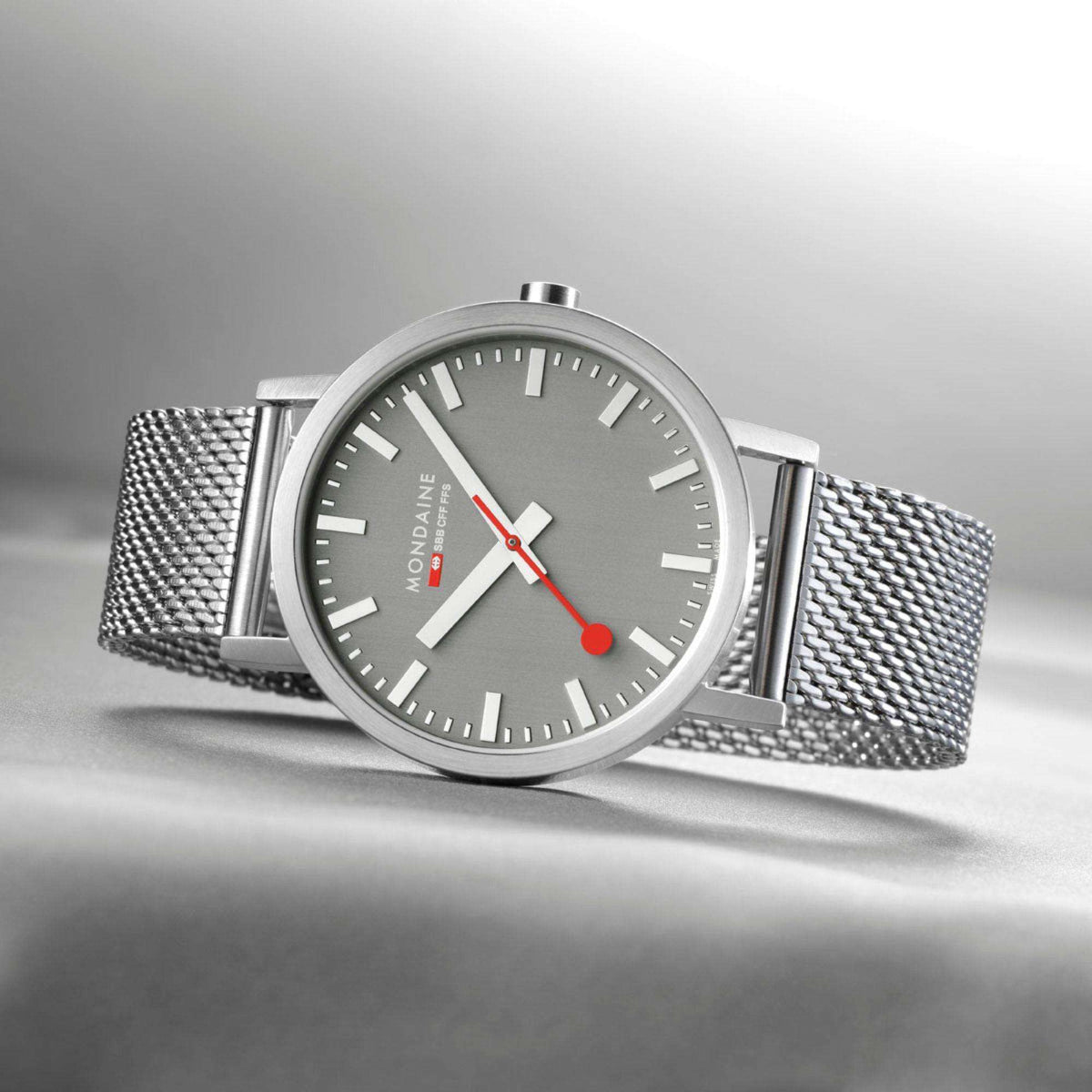 Grey dial stainless steel mesh bracelet watch with baton markers and red accent hands