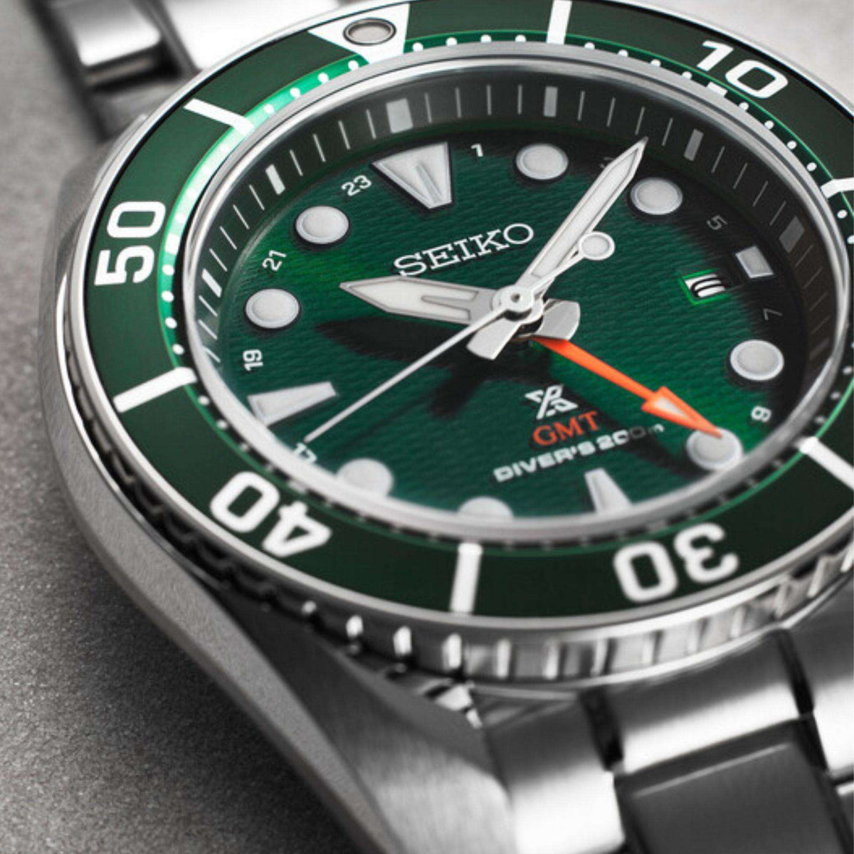 Close-up angled shot focusing on the green dial, luminous indices, and steel casing of the Seiko Prospex Aqua Sumo GMT Green Dial Steel Bracelet Men's Watch SFK003J1.