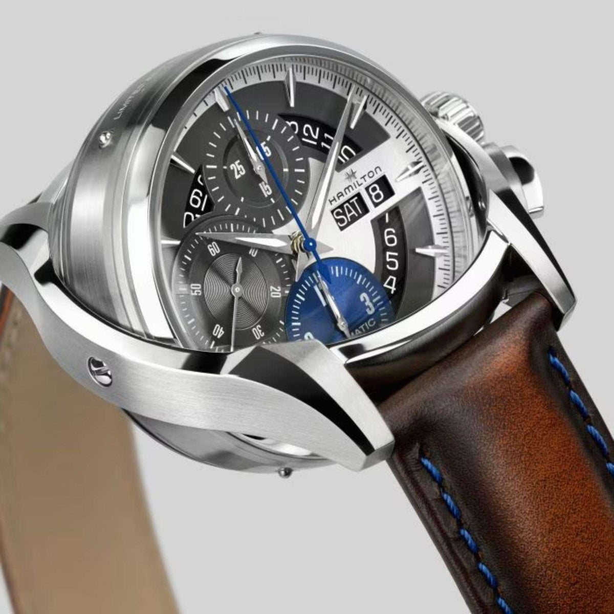 Men's silver automatic wristwatch front view with brown leather strap and blue subdial 8