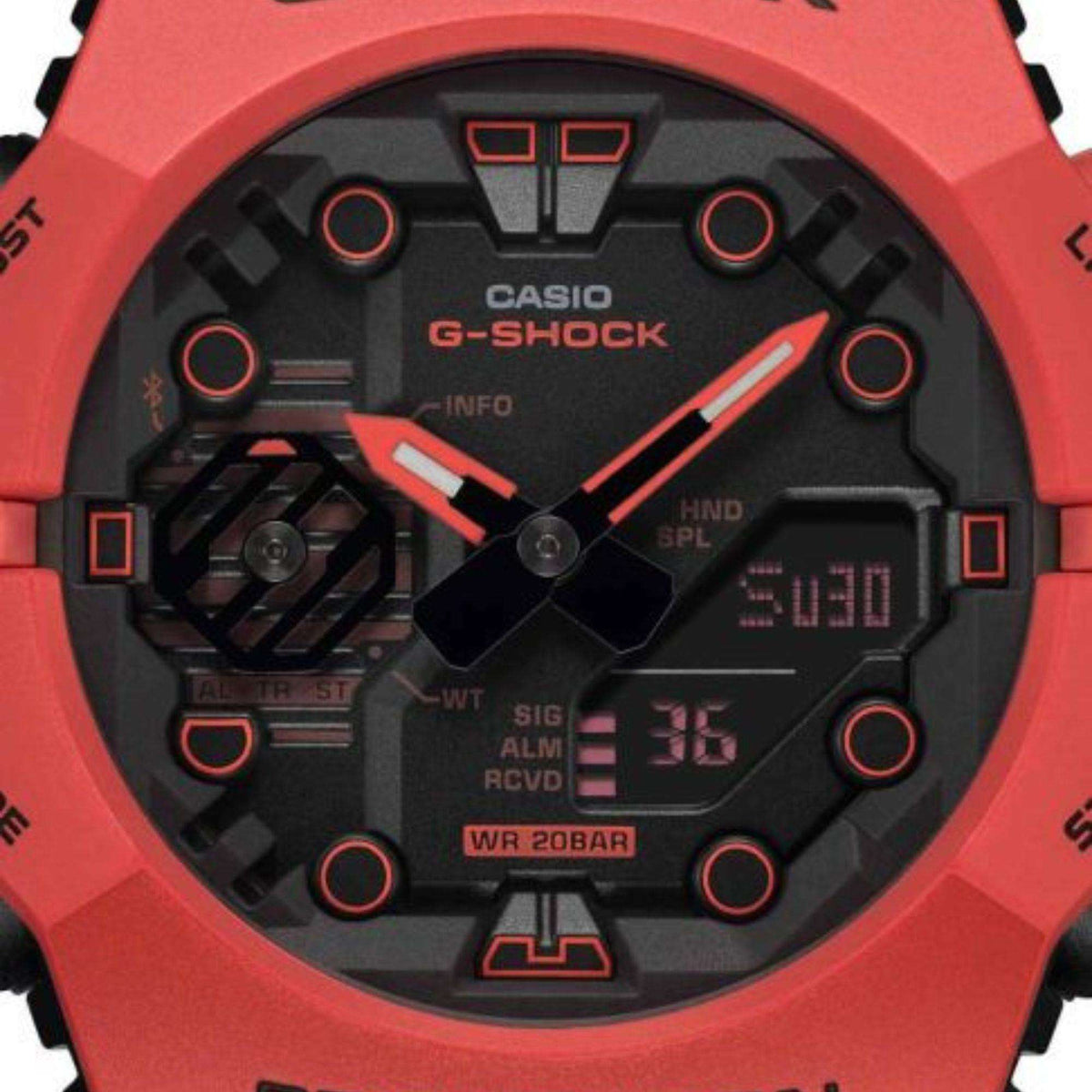 Red G-Shock digital-analog watch face close-up with black dial and red indexes
