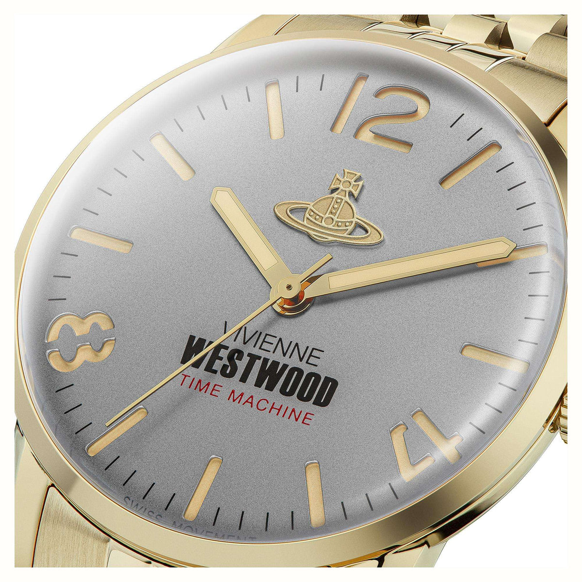 Gold watch face closeup: grey dial with gold markers, hands, and Time Machine logo