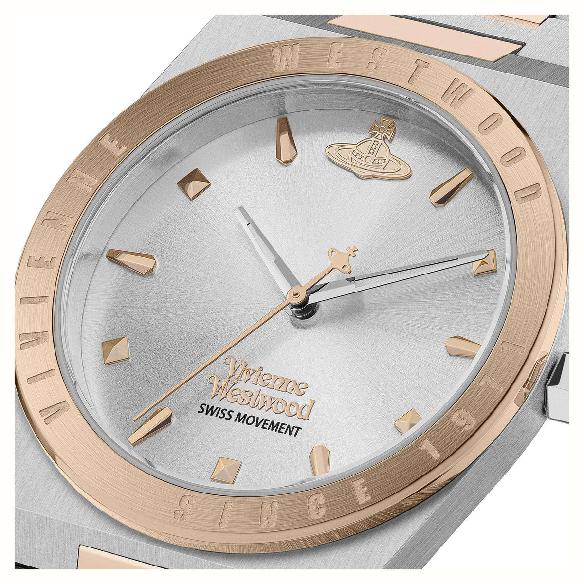 Close-up of silver dial two-tone watch with rose-gold hands and center emblem