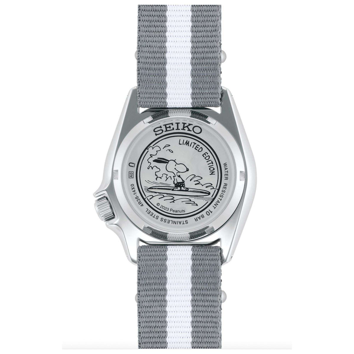 The stainless steel case back of the Seiko 5 Sports X Peanuts Surfboard Limited Edition Automatic White Dial Watch SRPK25K1 featuring an engraved illustration of Snoopy surfing.