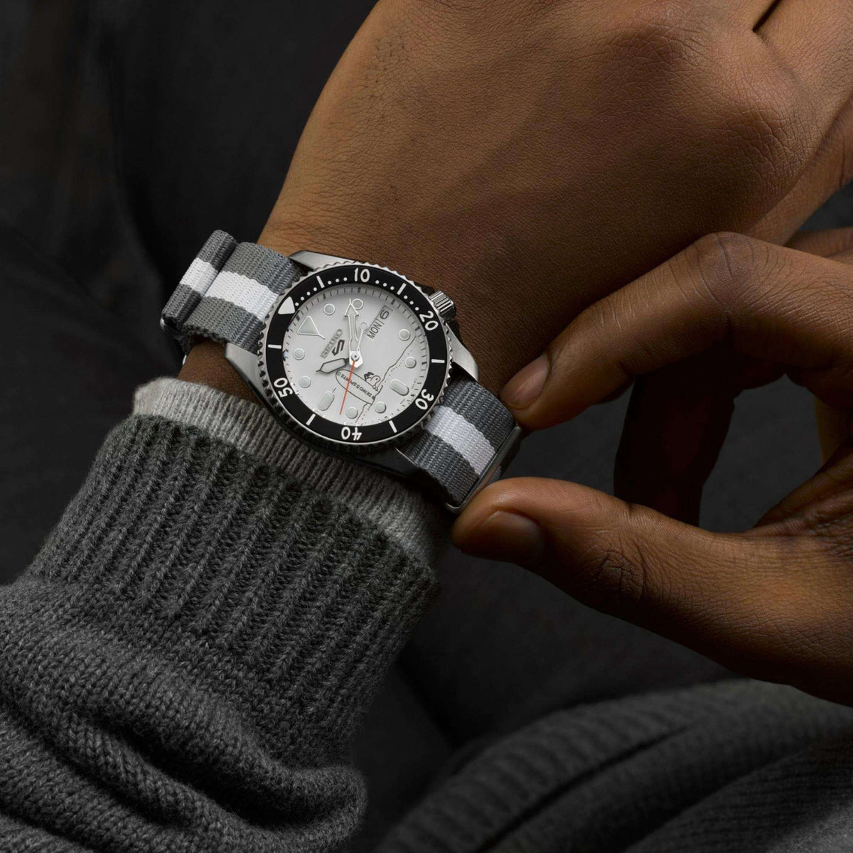 Close-up of the Seiko 5 Sports X Peanuts Surfboard watch SRPK25K1 worn on a wrist